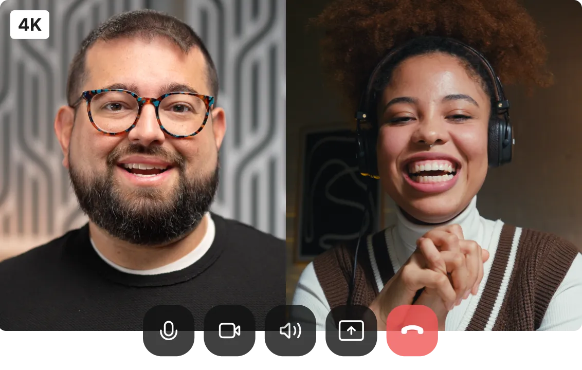 Video call screen showing a smiling man with glasses and beard on the left and a joyful woman with headphones and curly hair on the right.